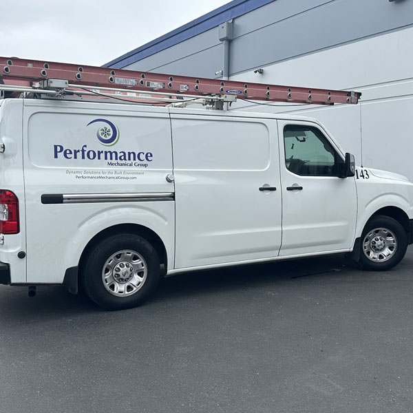 Performance Mechanical Group’s company branded truck in parking lot.