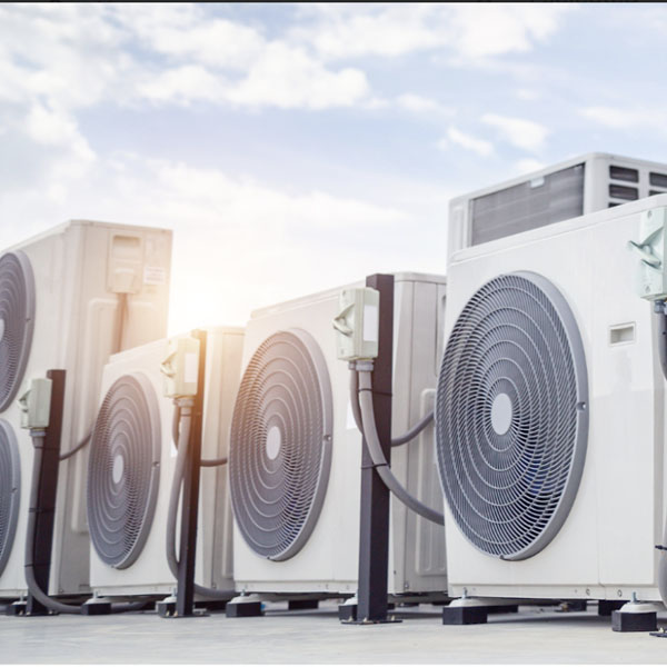 Row of HVAC units on a building's rooftop, installed by Performance Mechanical Group.