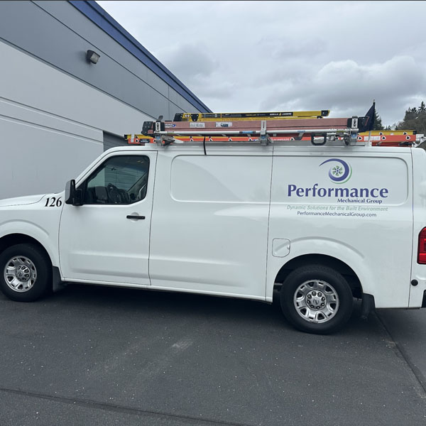 Performance Mechanical Group’s company branded truck in parking lot.