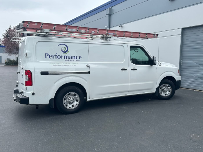 Performance Mechanical Group’s branded work truck sitting in parking lot outside of warehouse.