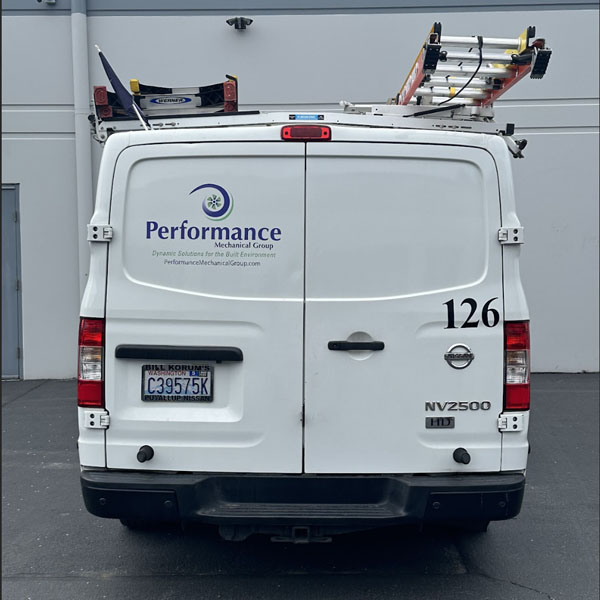 Performance Mechanical Group's HVAC truck in parking lot outside of warehouse.