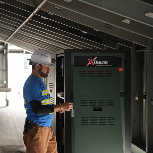 PMG_706 Performance Mechanical Group’s technician working on unit in new construction.