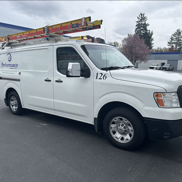 Performance Mechanical Group’s company branded truck in parking lot.