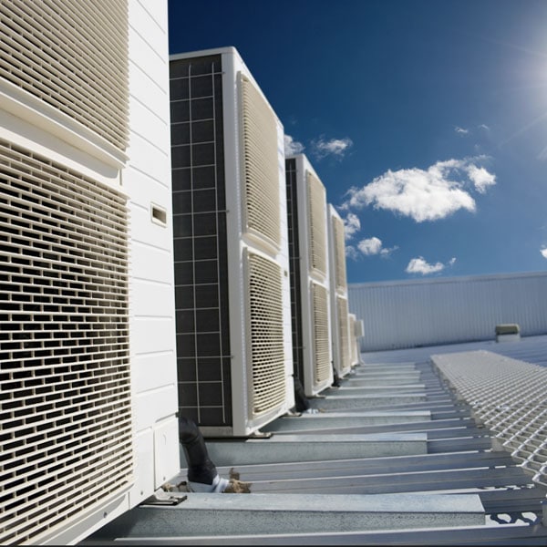Should I Repair or Replace My Commercial Freezer? Photo of Refrigeration units installed on a roof of a building.